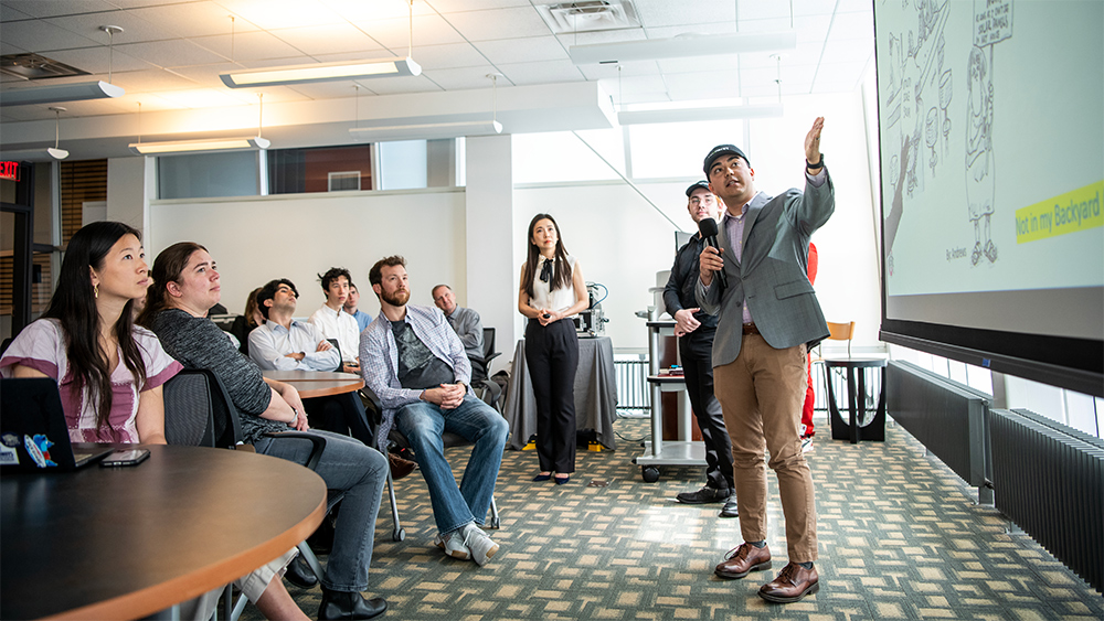 Students presenting collaborative class projects to classmates and industry partners in the John Glenn School of Public Affairs.