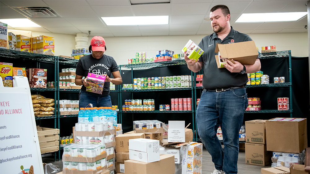 Buckeye Food Alliance food pantry stocking during coronavirus shutdown. Nick Fowler and Michaela Martin.