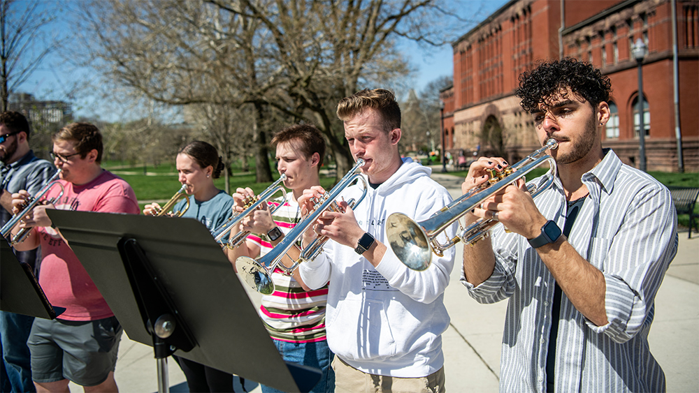 The OSU Trumpet Ensemble, a class within the School of Music in the College of Arts and Sciences,
practices outdoors near the Oval and Hayes Hall on a sunny spring day.