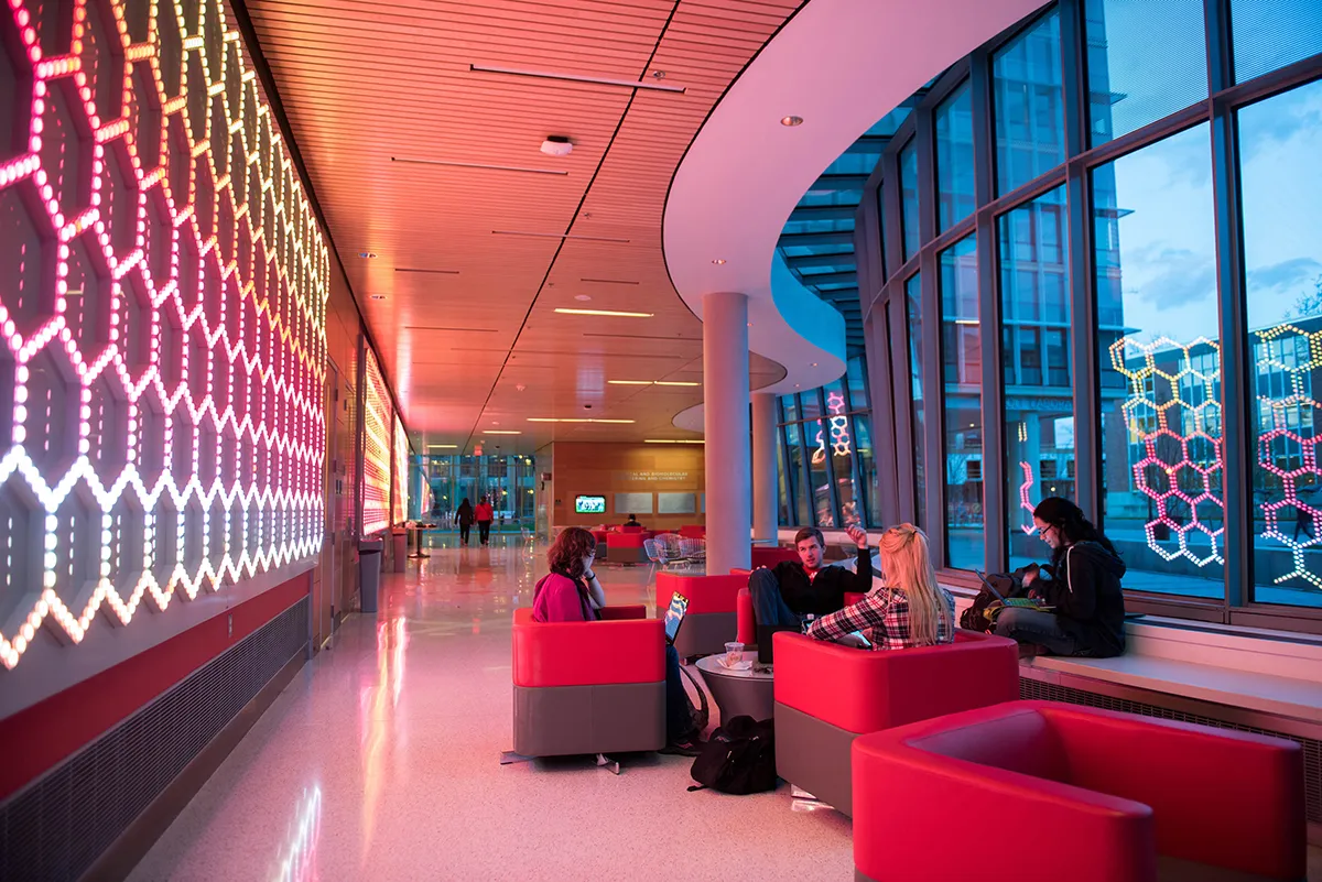 Students interact while sitting in the lobby of the Chemical and Biomolecular Engineering and Chemistry building.