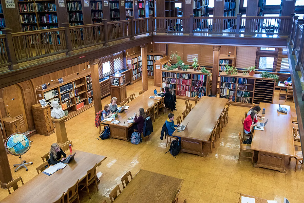 An overhead view of students working at tables in the Orton Hall library.