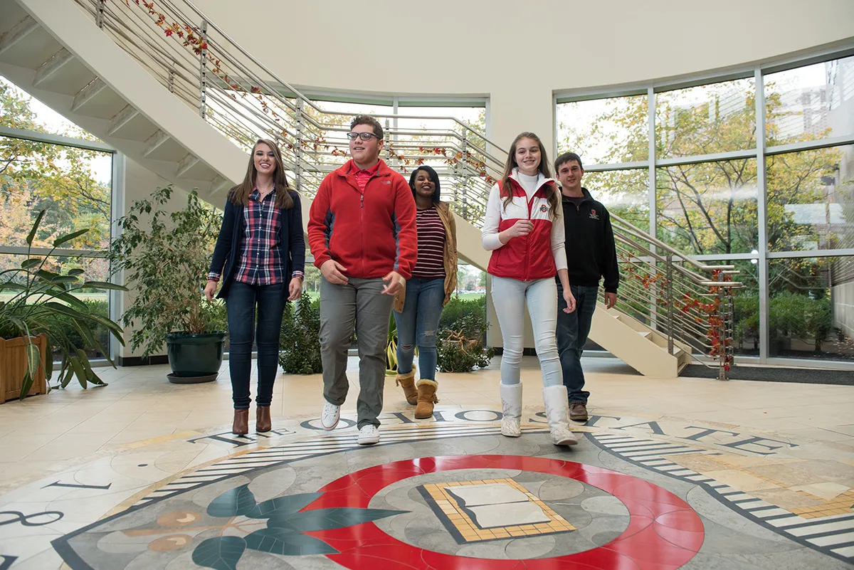 Five students walking toward the camera in Maynard Hall at Ohio State Marion.